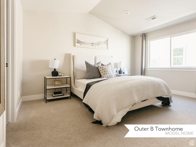 bedroom with lofted ceiling, light colored carpet, visible vents, and baseboards