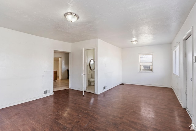 171 17th St, Ogden, UT 84404 - unfurnished bedroom featuring wood finished floors, baseboards, a textured ceiling, and ensuite bathroom