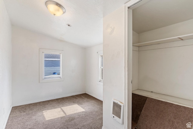 171 17th St, Ogden, UT 84404 - unfurnished bedroom with lofted ceiling, heating unit, carpet flooring, multiple windows, and baseboards
