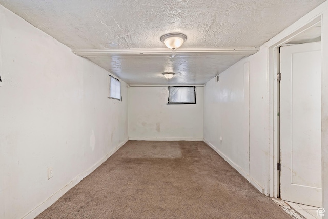 171 17th St, Ogden, UT 84404 - below grade area featuring carpet, a textured ceiling, and baseboards