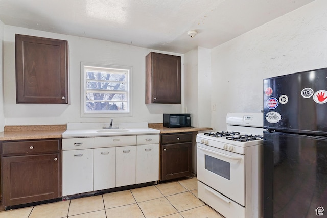 171 17th St, Ogden, UT 84404 - kitchen with black appliances, light tile patterned floors, light countertops, and dark brown cabinets