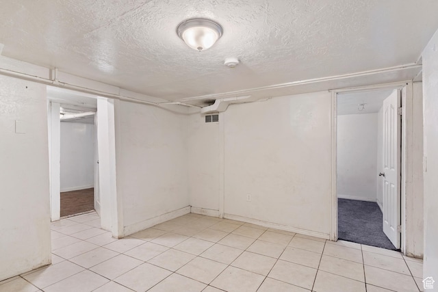171 17th St, Ogden, UT 84404 - finished basement with a textured ceiling, light tile patterned floors, and baseboards
