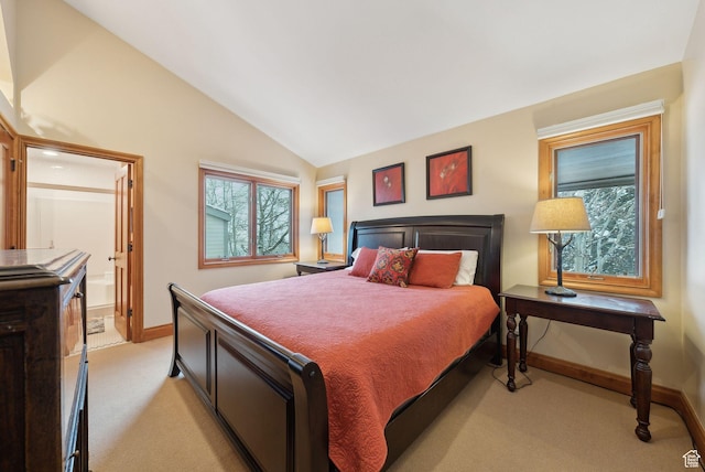 bedroom featuring connected bathroom, baseboards, light colored carpet, and vaulted ceiling
