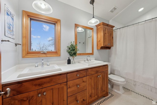 full bath featuring lofted ceiling, toilet, visible vents, and a sink