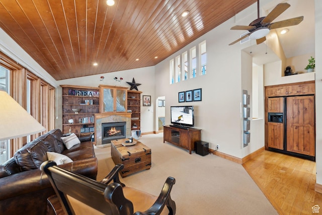 living room with baseboards, vaulted ceiling, recessed lighting, wooden ceiling, and a warm lit fireplace