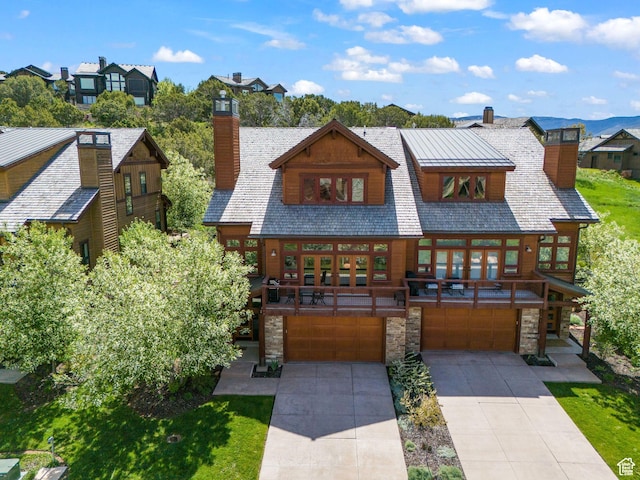 292 N Abajo Peak Way, Heber City, UT 84032 - view of front of house with a chimney, stone siding, a garage, and driveway