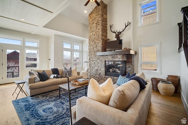 292 N Abajo Peak Way, Heber City, UT 84032 - living room featuring a stone fireplace, hardwood / wood-style floors, ceiling fan, a high ceiling, and beamed ceiling