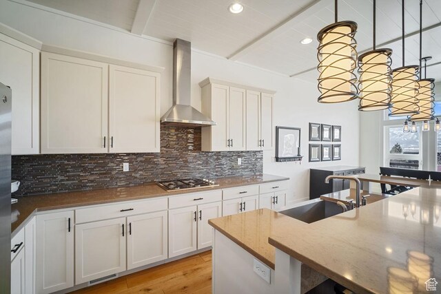 292 N Abajo Peak Way, Heber City, UT 84032 - kitchen featuring wall chimney exhaust hood, a sink, beam ceiling, stainless steel gas cooktop, and backsplash