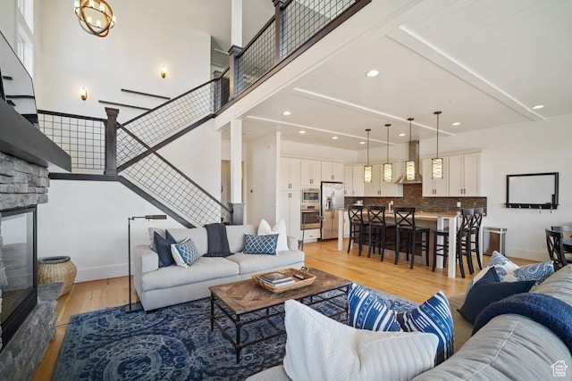 292 N Abajo Peak Way, Heber City, UT 84032 - living room with light wood-type flooring, stairway, recessed lighting, a high ceiling, and baseboards