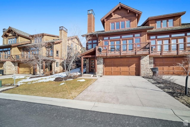 292 N Abajo Peak Way, Heber City, UT 84032 - view of front of property with a garage, stone siding, driveway, a chimney, and a balcony