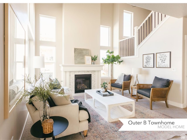 606 W 4500 S Unit 327, Mapleton, UT 84664 - living room featuring a towering ceiling, a glass covered fireplace, and carpet floors
