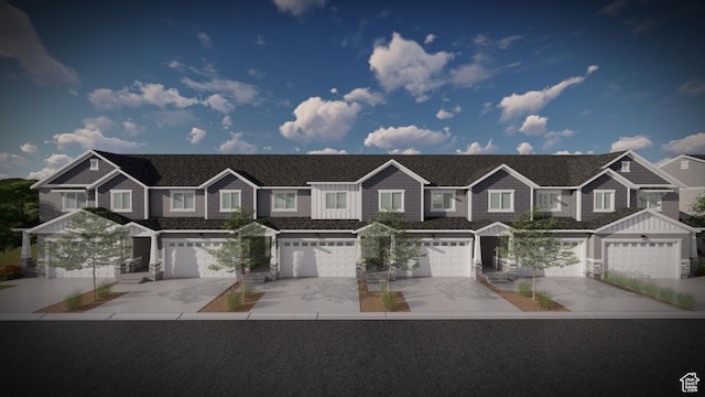 view of property featuring a residential view, an attached garage, and driveway