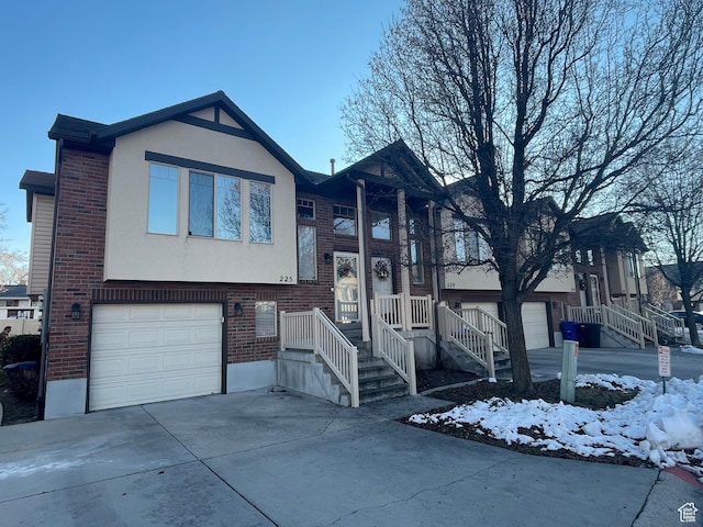 225 W Lyman Ln, Bountiful, UT 84010 - raised ranch with concrete driveway, an attached garage, brick siding, and stucco siding