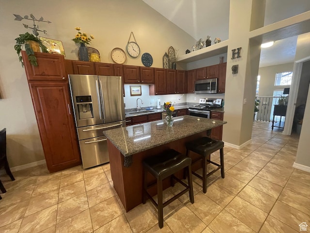 225 W Lyman Ln, Bountiful, UT 84010 - kitchen featuring high vaulted ceiling, a breakfast bar, a sink, a kitchen island, and stainless steel appliances