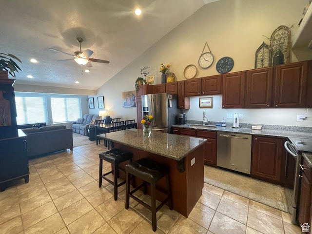 225 W Lyman Ln, Bountiful, UT 84010 - kitchen with a center island, appliances with stainless steel finishes, a kitchen breakfast bar, a ceiling fan, and a sink