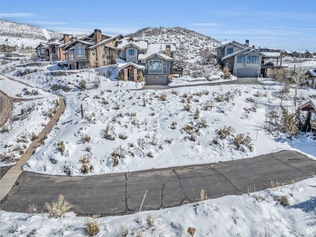 10740 N Hideout Trl, Hideout, UT 84036 - snowy yard with a garage and a residential view