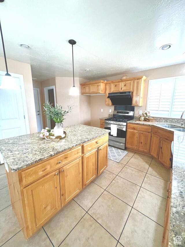 15 E 1100 S, Vernal, UT 84078 - kitchen featuring a sink, under cabinet range hood, light tile patterned floors, light stone countertops, and stainless steel range with gas stovetop
