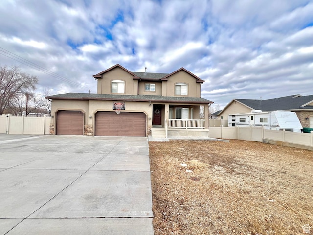 view of front of property featuring stucco siding, driveway, a porch, fence, and a garage