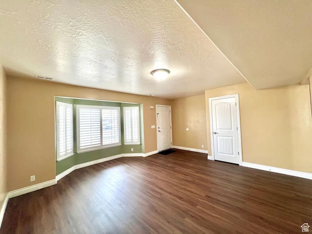 15 E 1100 S, Vernal, UT 84078 - empty room featuring visible vents, baseboards, a textured ceiling, and dark wood-style flooring