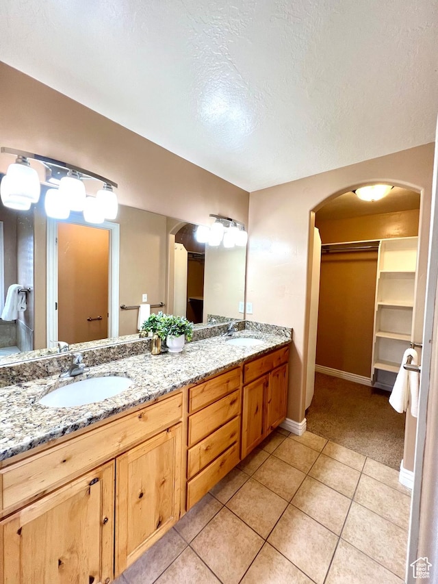 15 E 1100 S, Vernal, UT 84078 - bathroom with a sink, a spacious closet, double vanity, and tile patterned floors