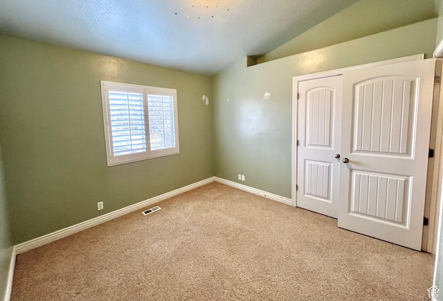15 E 1100 S, Vernal, UT 84078 - unfurnished bedroom featuring visible vents, baseboards, carpet floors, vaulted ceiling, and a closet