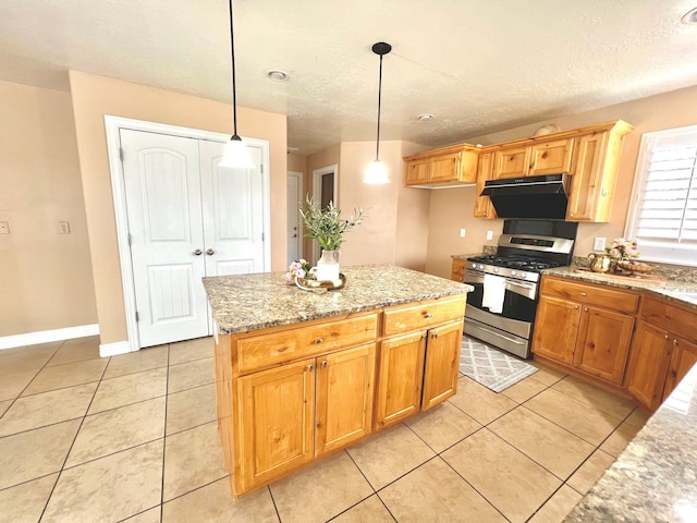 15 E 1100 S, Vernal, UT 84078 - kitchen with light stone counters, light tile patterned floors, stainless steel gas range oven, decorative light fixtures, and a center island