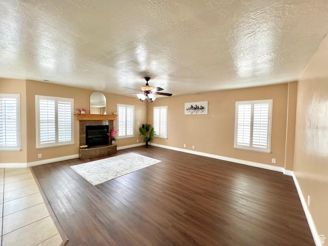 15 E 1100 S, Vernal, UT 84078 - unfurnished living room with a glass covered fireplace, baseboards, dark wood finished floors, and ceiling fan