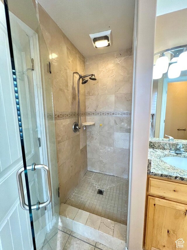 15 E 1100 S, Vernal, UT 84078 - bathroom featuring tile patterned floors, a shower stall, and vanity