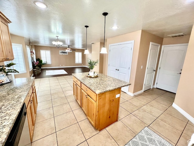 15 E 1100 S, Vernal, UT 84078 - kitchen featuring visible vents, light stone counters, a kitchen island, stainless steel dishwasher, and light tile patterned floors