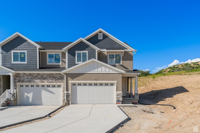 588 W 4500 S Unit 330, Mapleton, UT 84664 - view of front facade featuring stone siding, driveway, an attached garage, and board and batten siding