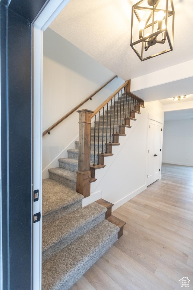1183 S 1335 E Unit 76, Garland, UT 84312 - stairway with a chandelier, baseboards, and wood finished floors