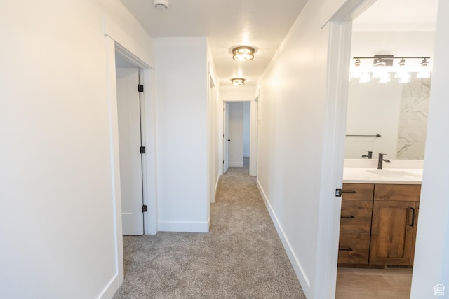 1183 S 1335 E Unit 76, Garland, UT 84312 - corridor featuring a sink, baseboards, and light colored carpet