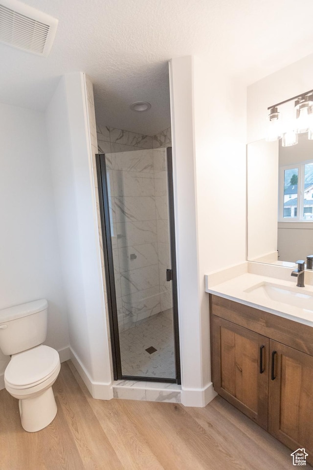1183 S 1335 E Unit 76, Garland, UT 84312 - full bath with vanity, wood finished floors, visible vents, a marble finish shower, and toilet