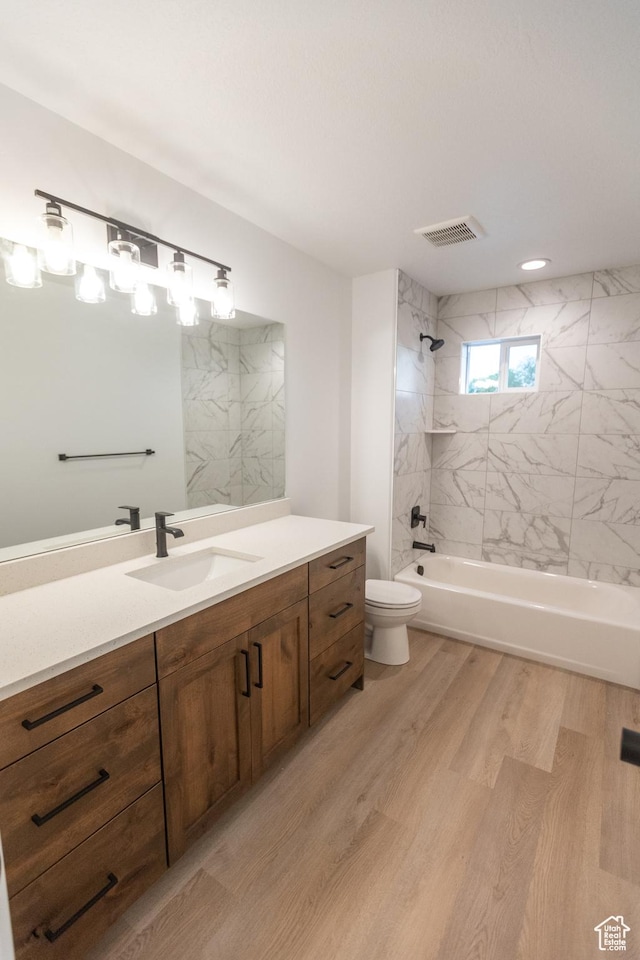 1183 S 1335 E Unit 76, Garland, UT 84312 - bathroom featuring vanity, wood finished floors, visible vents, bathing tub / shower combination, and toilet