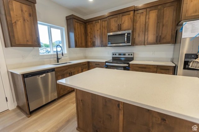 1183 S 1335 E Unit 76, Garland, UT 84312 - kitchen with a sink, stainless steel appliances, light countertops, and light wood finished floors