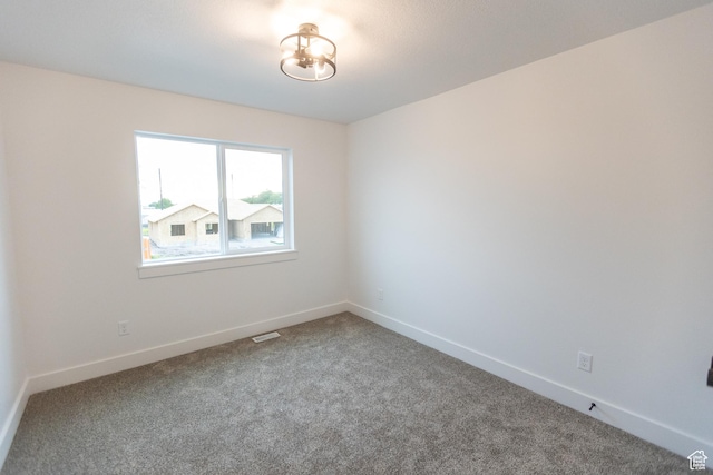 1183 S 1335 E Unit 76, Garland, UT 84312 - unfurnished room with carpet flooring, visible vents, and baseboards