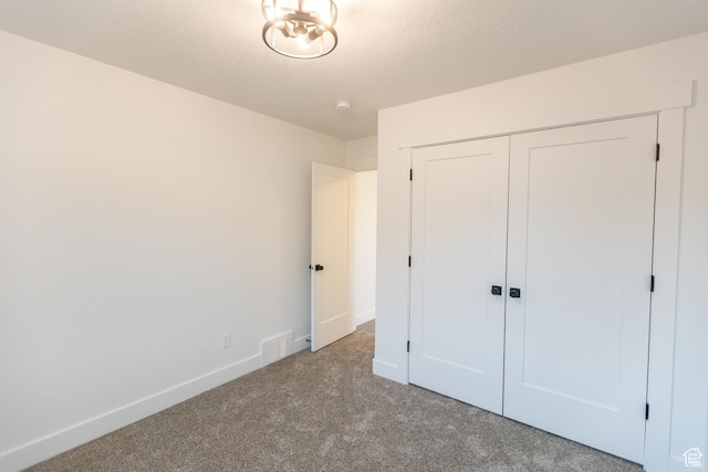 1183 S 1335 E Unit 76, Garland, UT 84312 - unfurnished bedroom with a closet, carpet flooring, visible vents, and baseboards