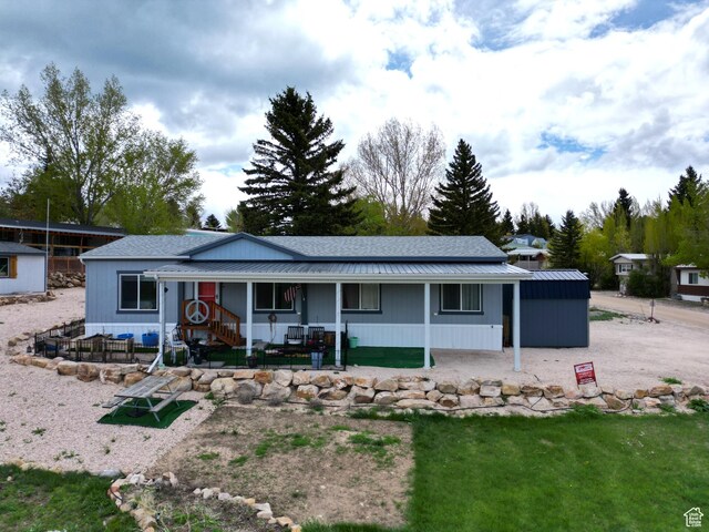 924 E Breeze Way Unit 106, Garden City, UT 84028 - view of front facade with a porch and metal roof
