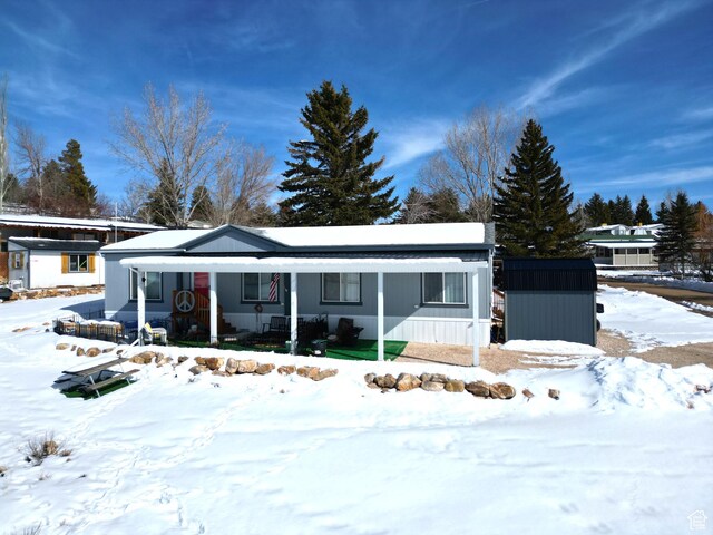 924 E Breeze Way Unit 106, Garden City, UT 84028 - view of front of home with a storage shed and an outdoor structure