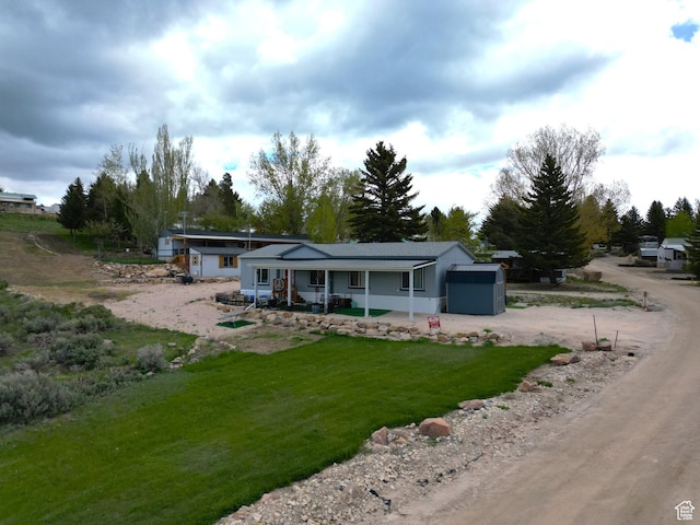 924 E Breeze Way Unit 106, Garden City, UT 84028 - back of property featuring driveway, a yard, and a porch