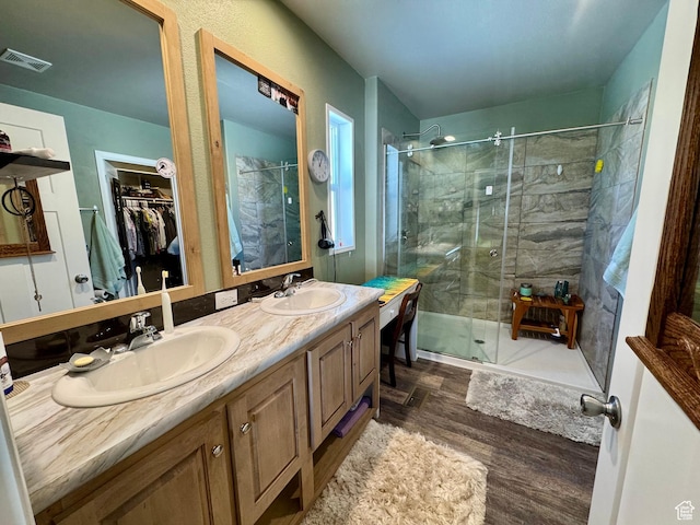 924 E Breeze Way Unit 106, Garden City, UT 84028 - full bath with a stall shower, wood finished floors, double vanity, and a walk in closet