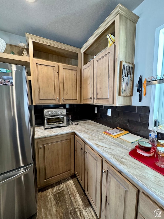 924 E Breeze Way Unit 106, Garden City, UT 84028 - kitchen featuring freestanding refrigerator, light countertops, dark wood-style flooring, decorative backsplash, and a textured ceiling