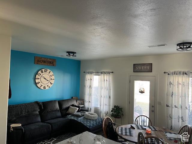 2048 W Brynn Ave S Unit 7, West Haven, UT 84401 - living room with wood finished floors, visible vents, and a textured ceiling