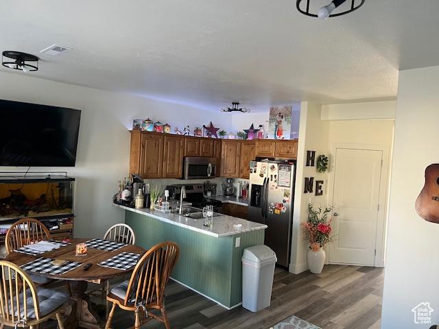 2048 W Brynn Ave S Unit 7, West Haven, UT 84401 - kitchen featuring dark wood finished floors, a peninsula, a sink, and stainless steel appliances