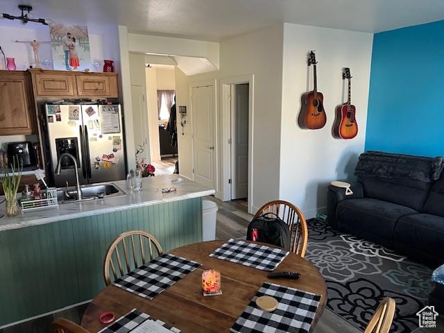2048 W Brynn Ave S Unit 7, West Haven, UT 84401 - interior space featuring light countertops, light wood-style flooring, brown cabinetry, stainless steel fridge, and a sink
