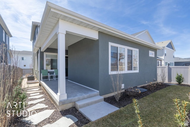 4672 W Tulip N, Cedar Hills, UT 84062 - view of front of house featuring a patio area, fence, a front lawn, and stucco siding