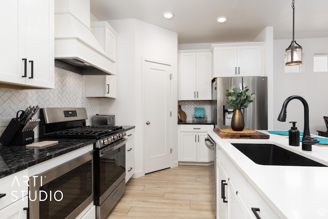 4672 W Tulip N, Cedar Hills, UT 84062 - kitchen featuring premium range hood, light wood-style flooring, white cabinets, stainless steel appliances, and a sink
