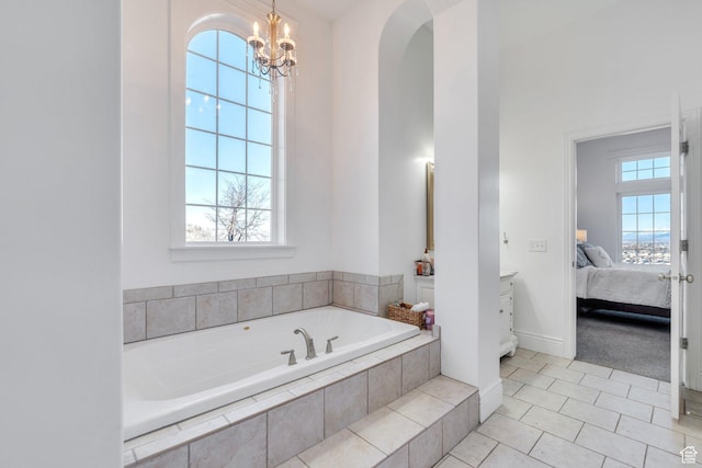 2382 S Spanish Oaks Dr, Spanish Fork, UT 84660 - ensuite bathroom with baseboards, connected bathroom, tile patterned floors, a bath, and a chandelier