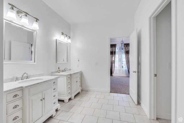 2382 S Spanish Oaks Dr, Spanish Fork, UT 84660 - bathroom featuring baseboards, tile patterned floors, two vanities, and a sink