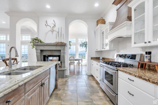 2382 S Spanish Oaks Dr, Spanish Fork, UT 84660 - kitchen with double oven range, a high end fireplace, light stone countertops, dishwasher, and a sink